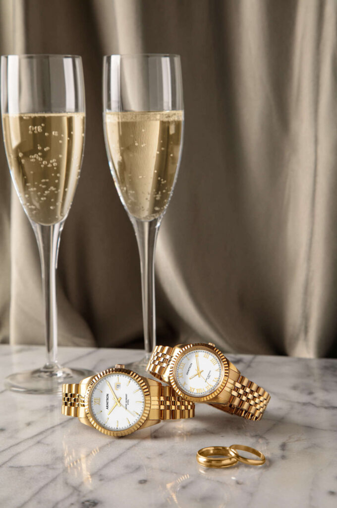 Ross-Rachel_20-5521_75-5873_05-24-2023_0047 Armitron Ross and Rachel watches in gold with champange glasses