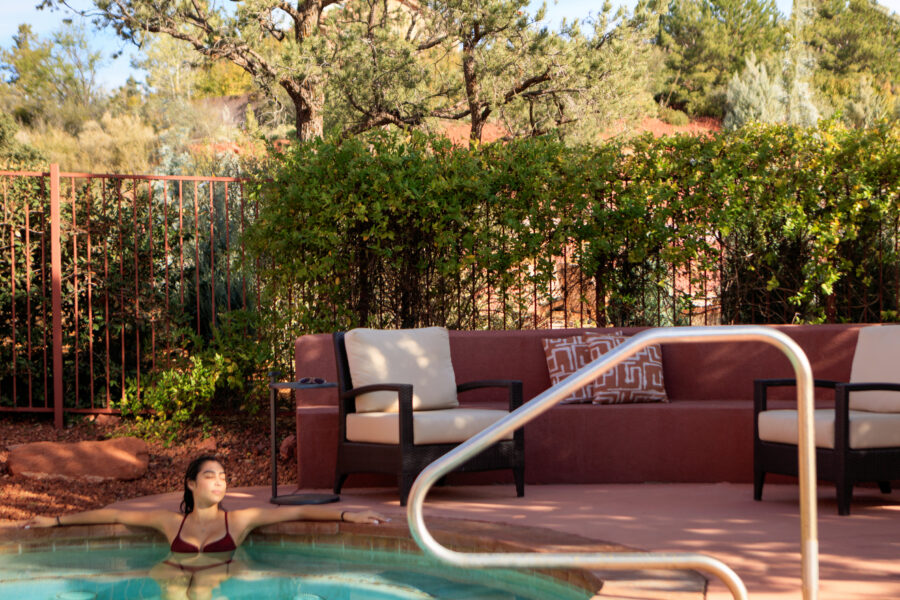 a woman lounges in a hot tub