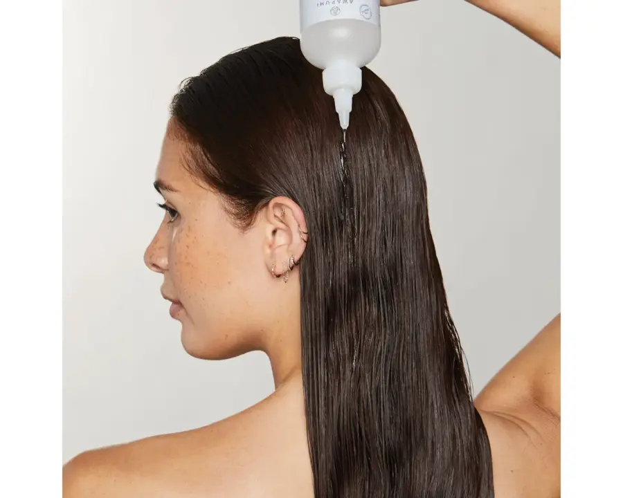 Paul Mitchell Professional Hair Products Awapuhi Wild Ginger Hydrasoft Glassing Treatment in usage on dark hair