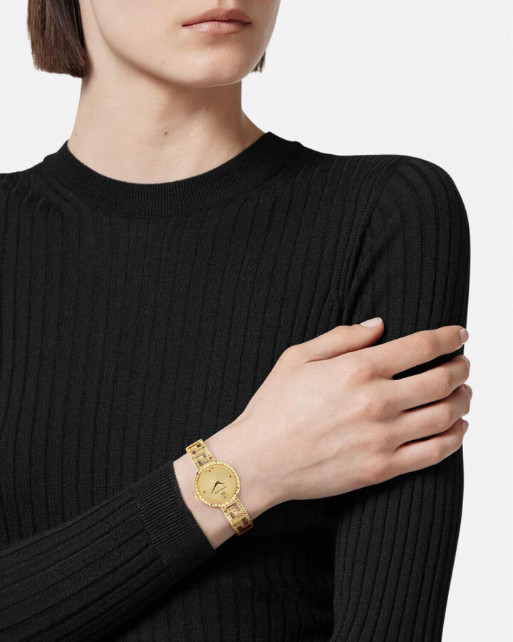 Model wearing Versace Greca Goddess gold watch