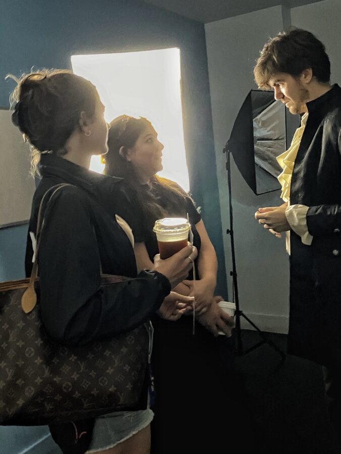 Two women interview a director