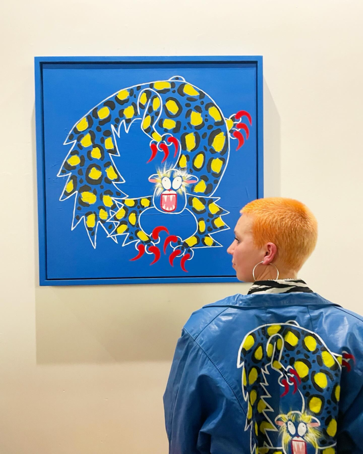 Elin Lundman with yellow monster painting and jacket