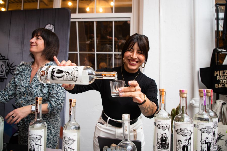 Woman at Bowl of Zole pouring spirits