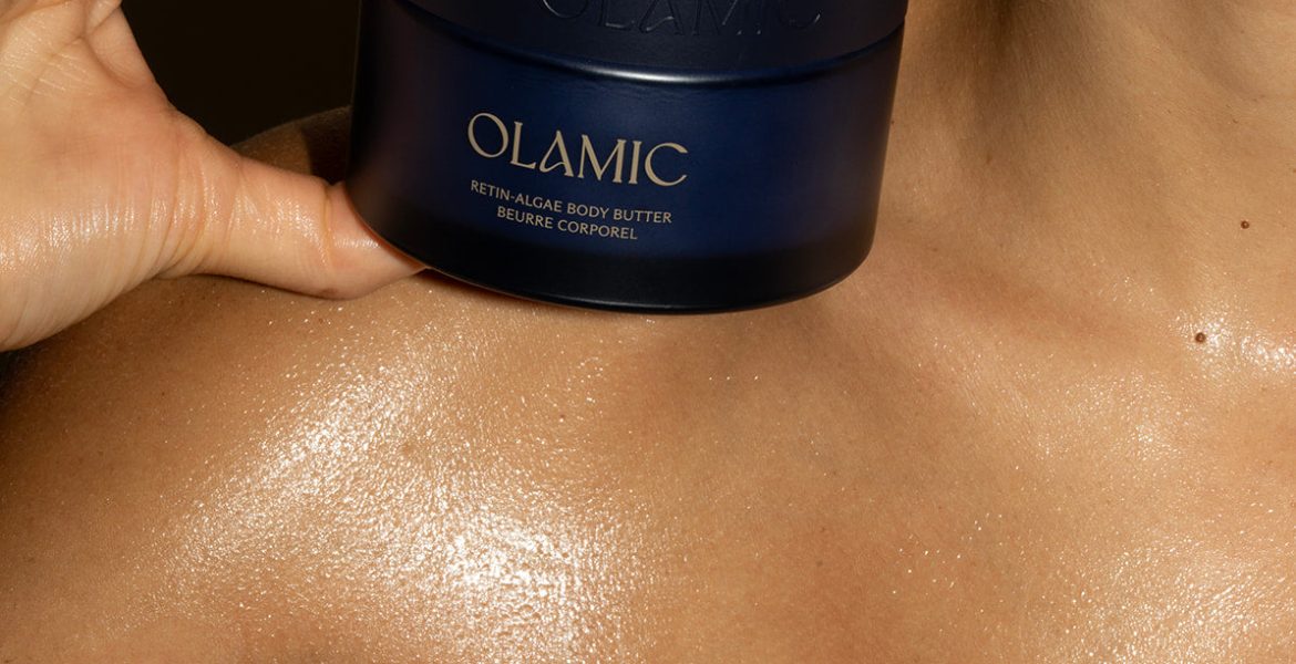 Jar of Olamic Body Butter on top of woman's shoulder