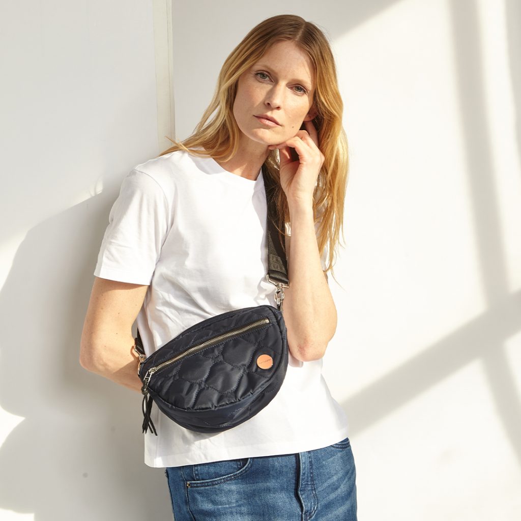 This silky smooth nylon bag transitions perfectly from the gym to date night thanks to its removable strap and incredible organization.